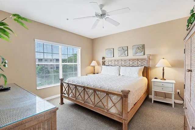 a bedroom with a bed a chandelier and a window