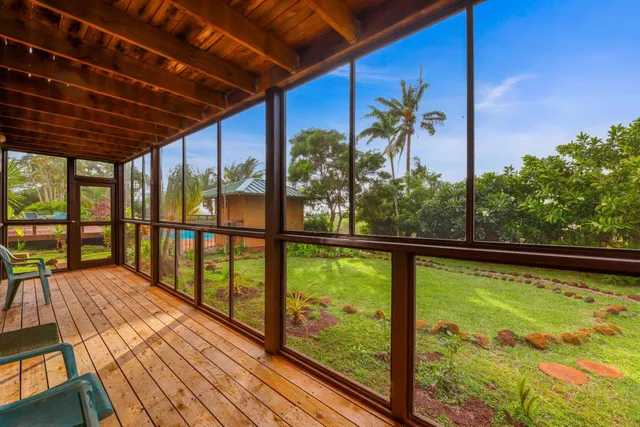 a bedroom with a bed and glass door