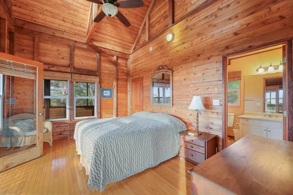 a bathroom with a sink a toilet a mirror and shower