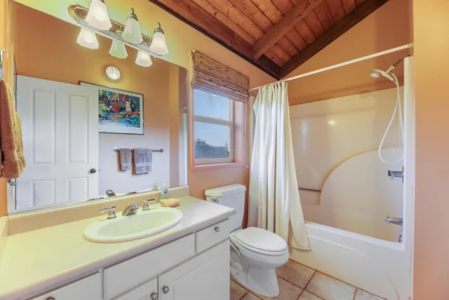 a bed sitting in a bedroom next to a large window