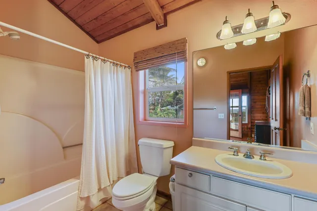 a bedroom with a bed and large window