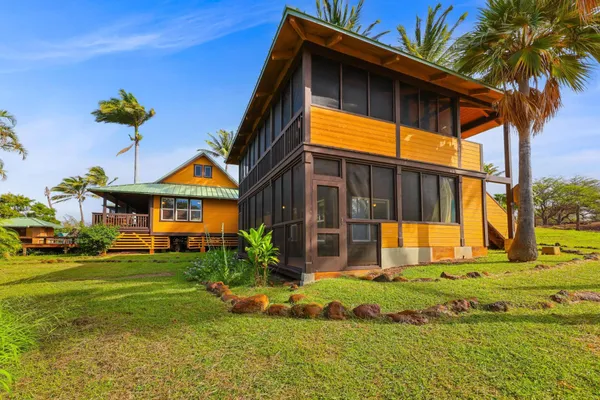 a view of a house with pool and chairs