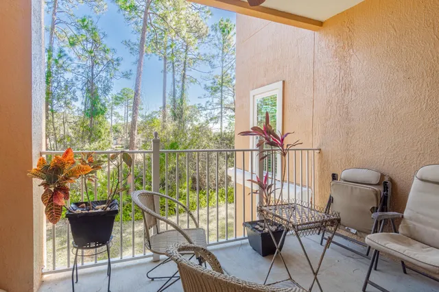 a view of a chairs and table in the balcony
