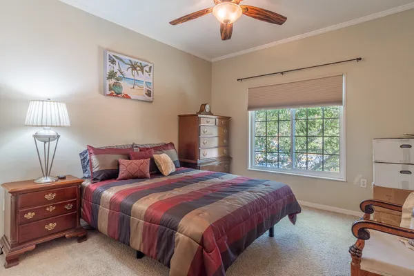 a bedroom with a bed and a mirror