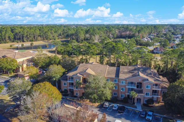 an aerial view of residential houses with outdoor space and parking