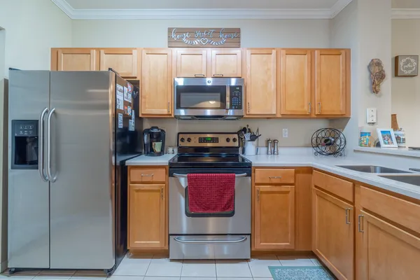 a kitchen with stainless steel appliances granite countertop a refrigerator and a stove