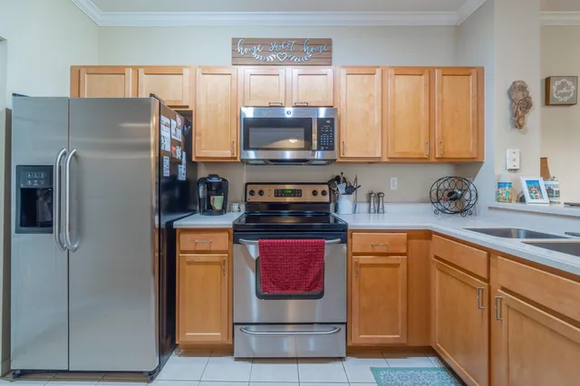 a kitchen with stainless steel appliances granite countertop a refrigerator and a stove