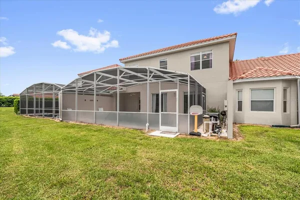 a view of a house with backyard sitting area and garden