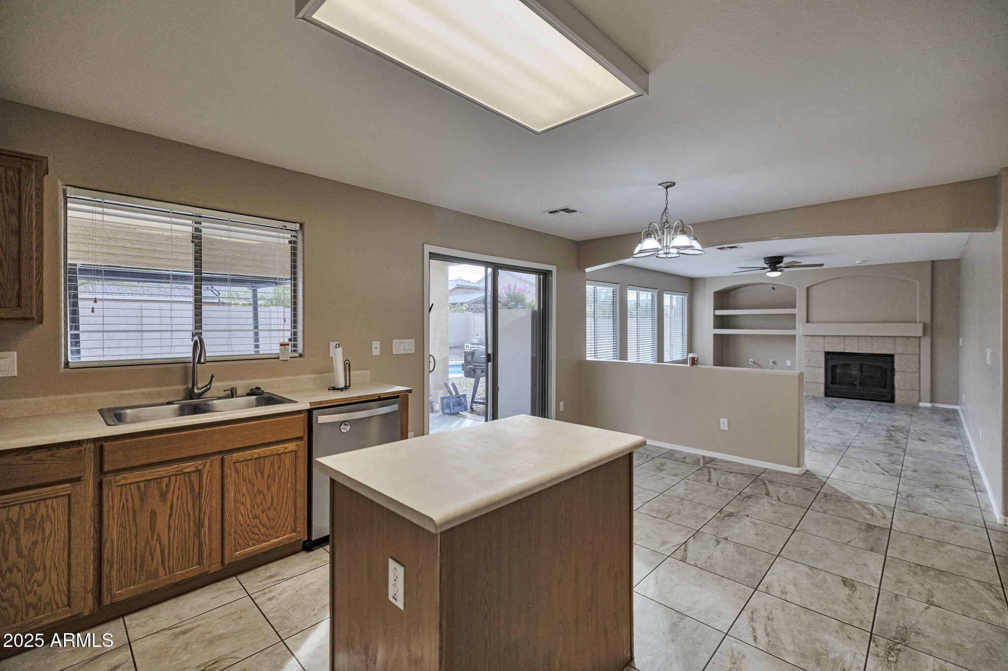 9705 West Riverside Avenue Tolleson, AZ 85353 - Photo 11 of 26 a kitchen with a stove a sink a microwave and dining table