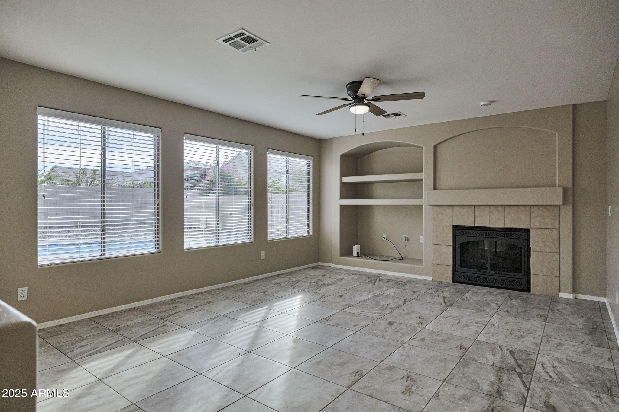 9705 West Riverside Avenue Tolleson, AZ 85353 - Photo 12 of 26 a view of an empty room with a fireplace and a window