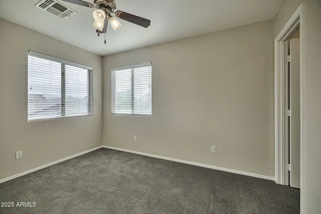 a view of a room with a ceiling fan and a window