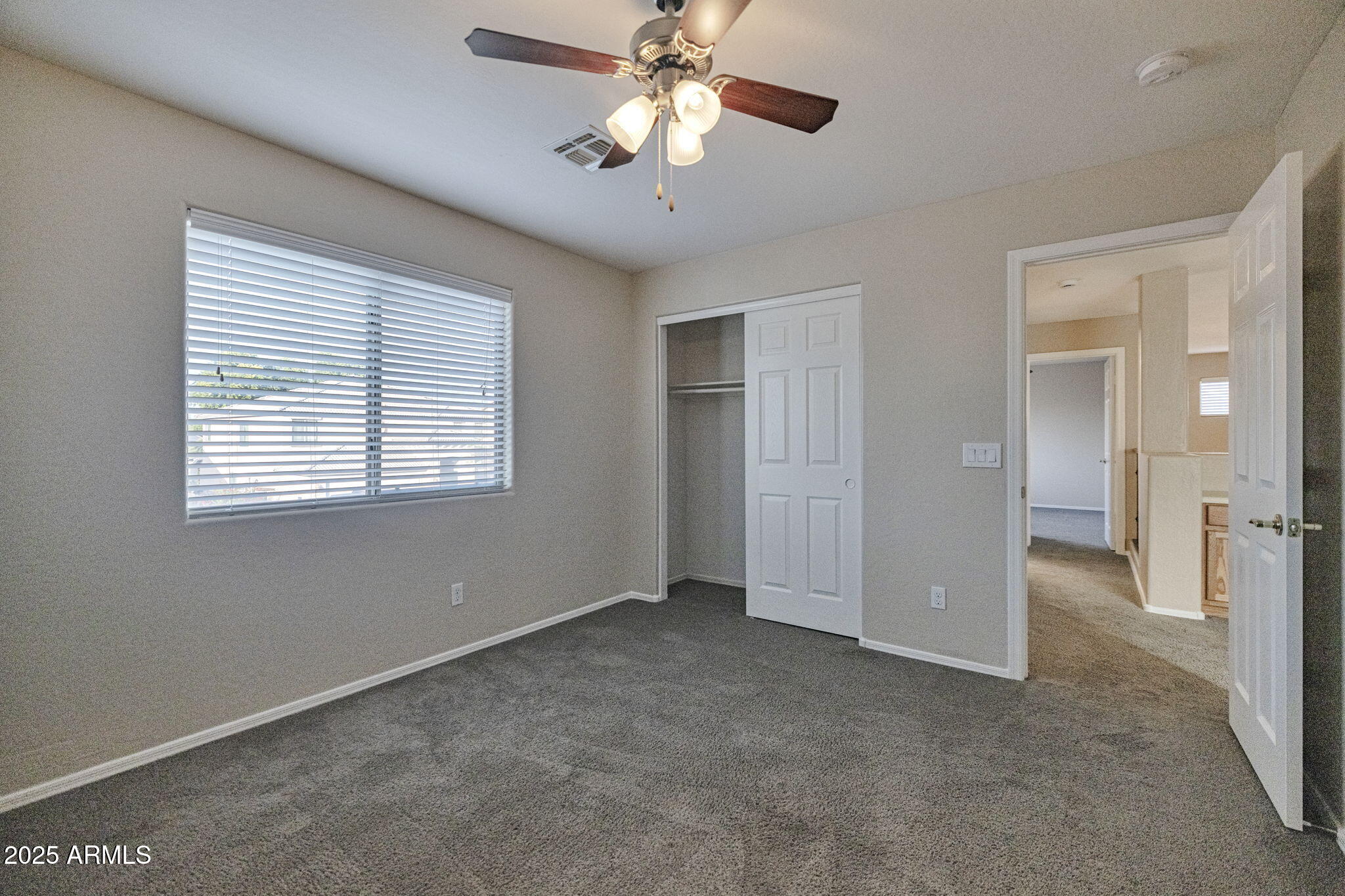 9705 West Riverside Avenue Tolleson, AZ 85353 - Photo 16 of 26 a view of a room with a ceiling fan and a window