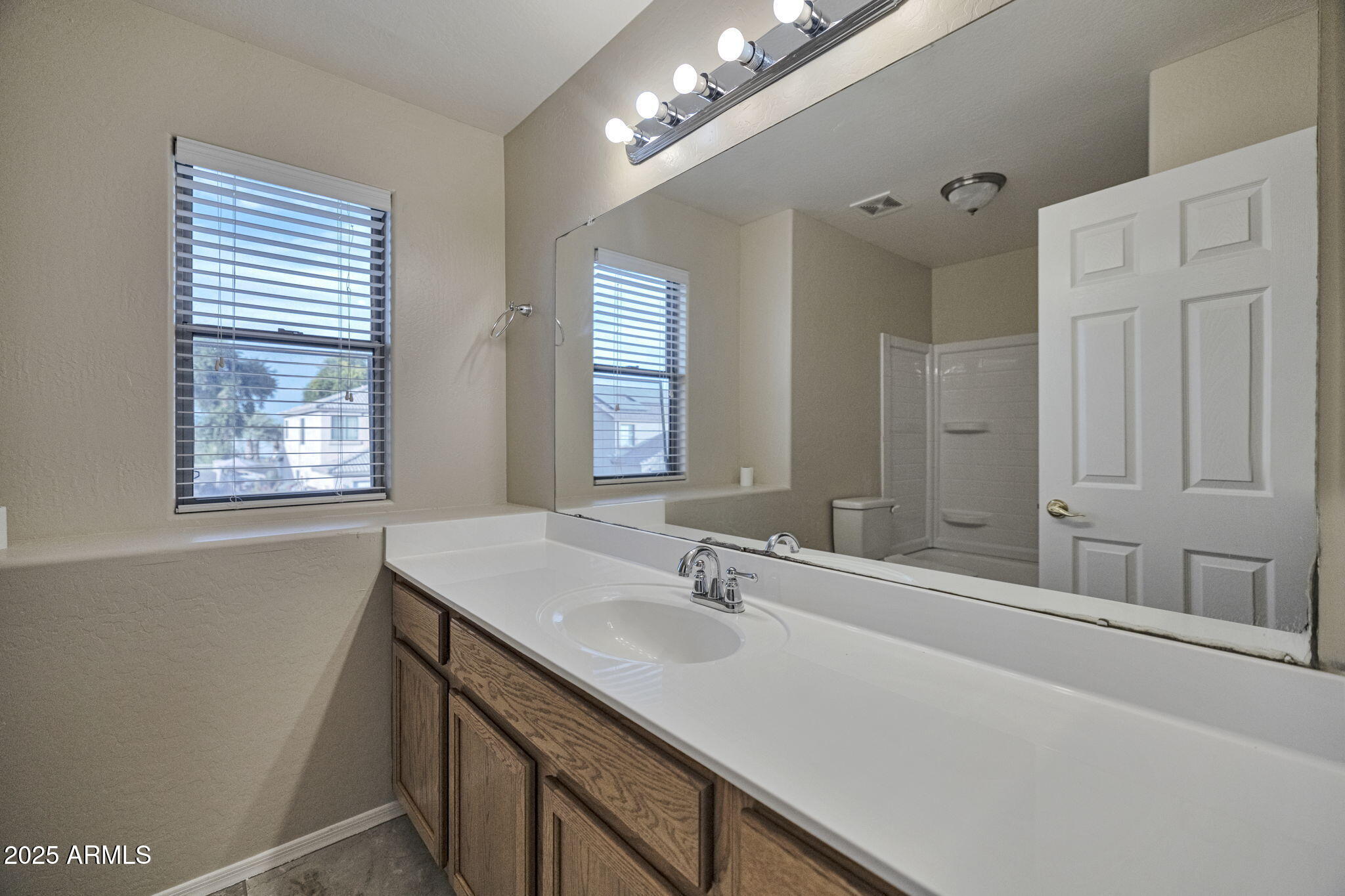 9705 West Riverside Avenue Tolleson, AZ 85353 - Photo 17 of 26 a bathroom with a sink double vanity and a mirror