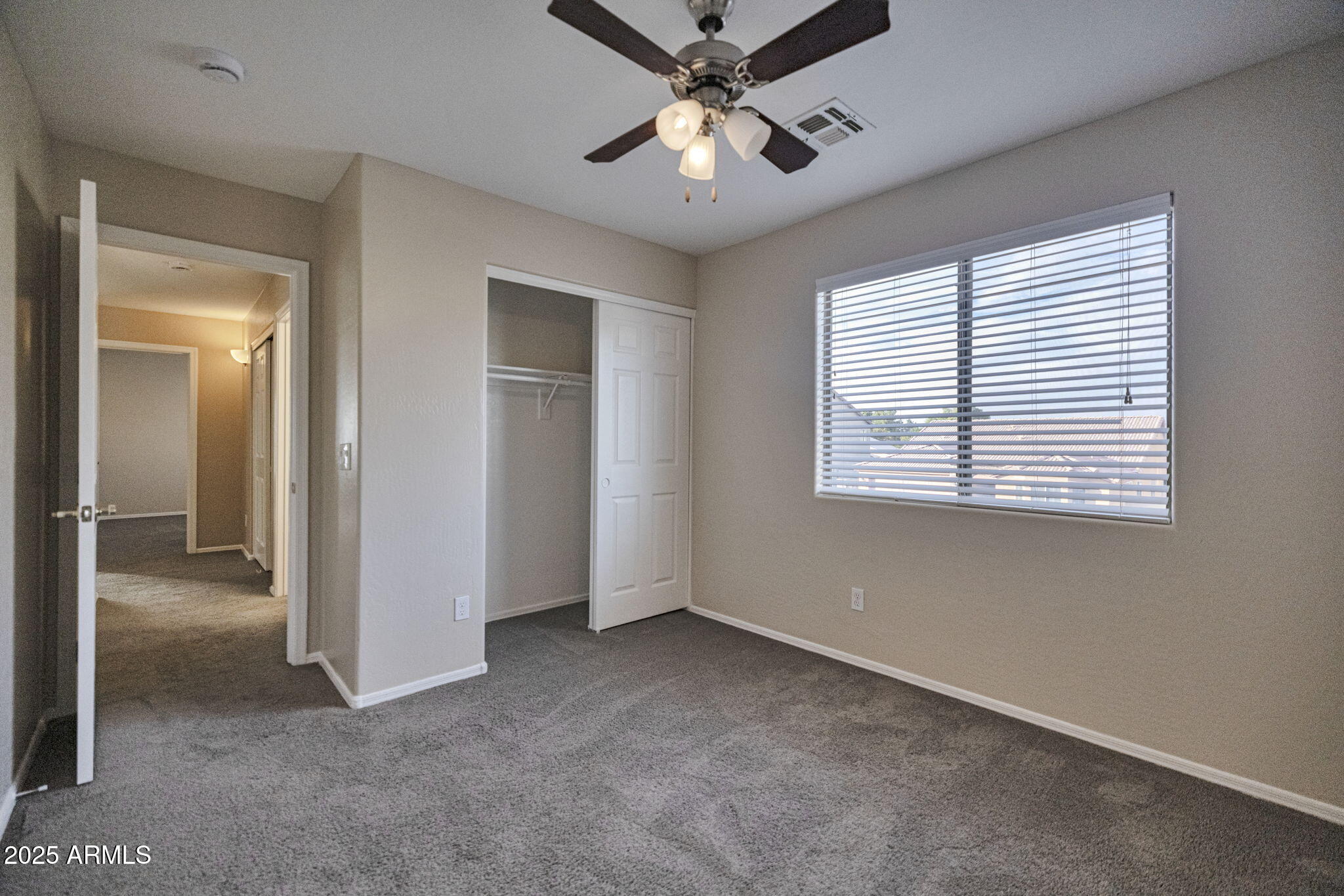 9705 West Riverside Avenue Tolleson, AZ 85353 - Photo 18 of 26 an empty room with windows and fan