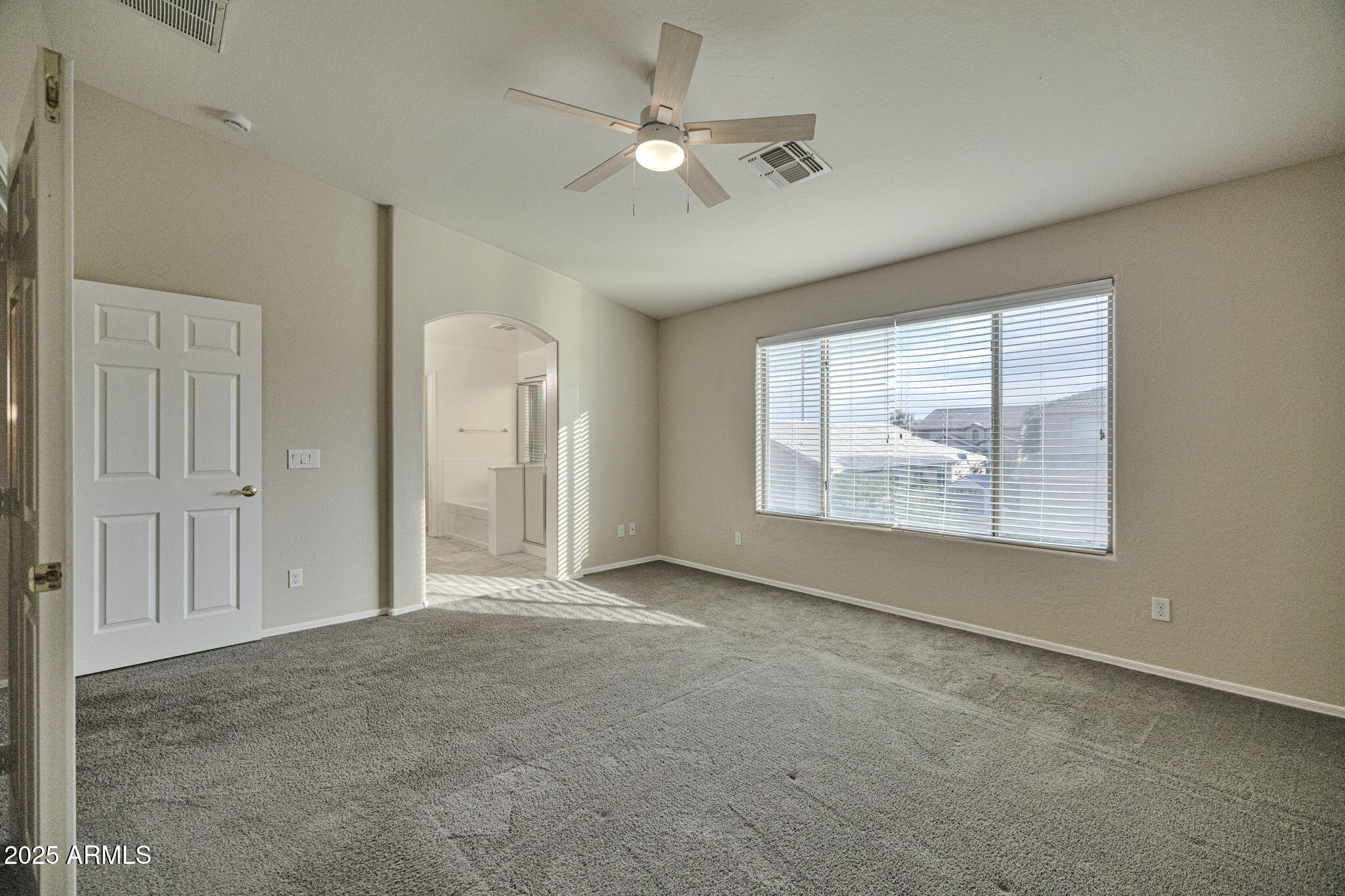 9705 West Riverside Avenue Tolleson, AZ 85353 - Photo 19 of 26 an empty room with windows and a ceiling fan