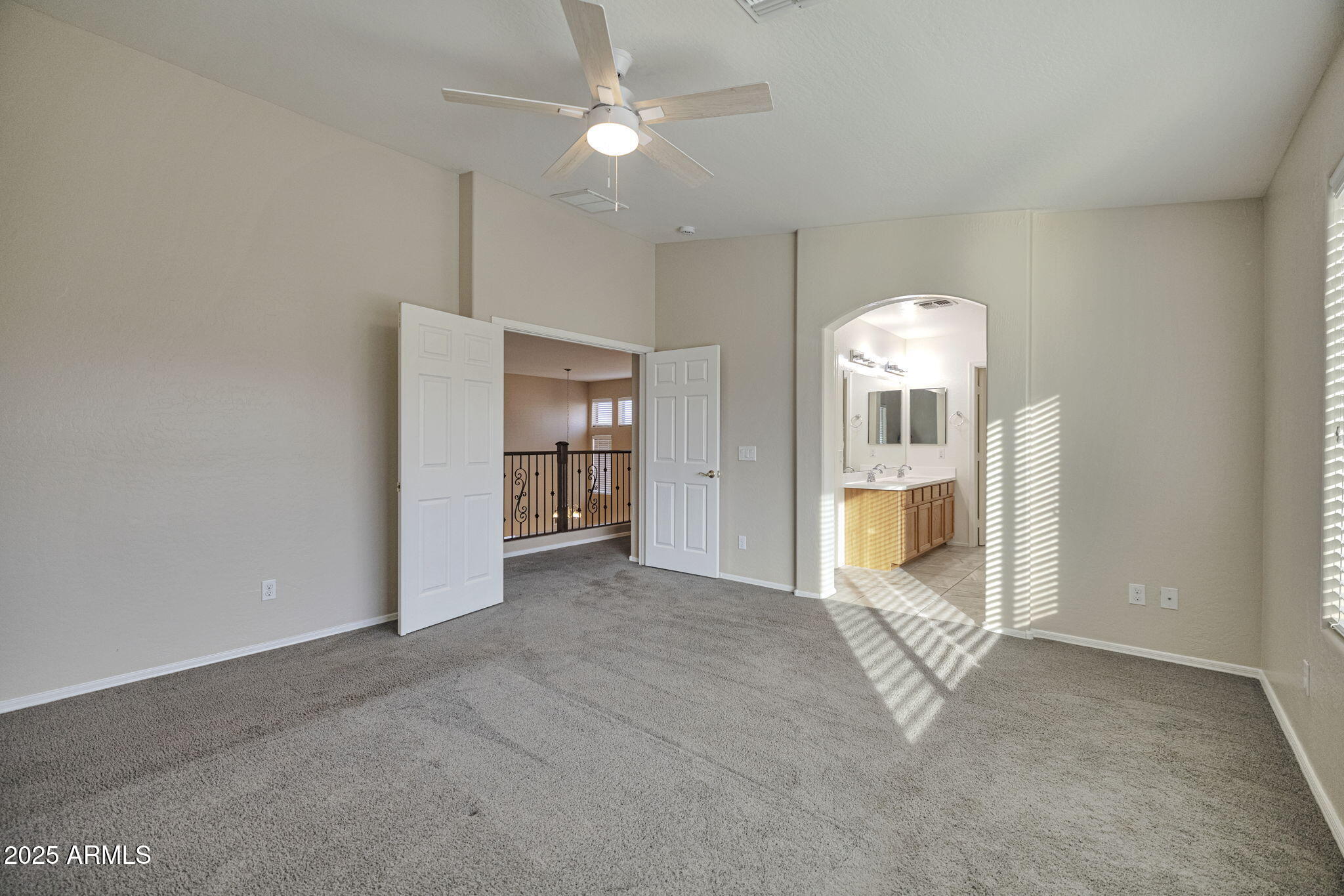 9705 West Riverside Avenue Tolleson, AZ 85353 - Photo 20 of 26 an empty room with chandelier fan and windows
