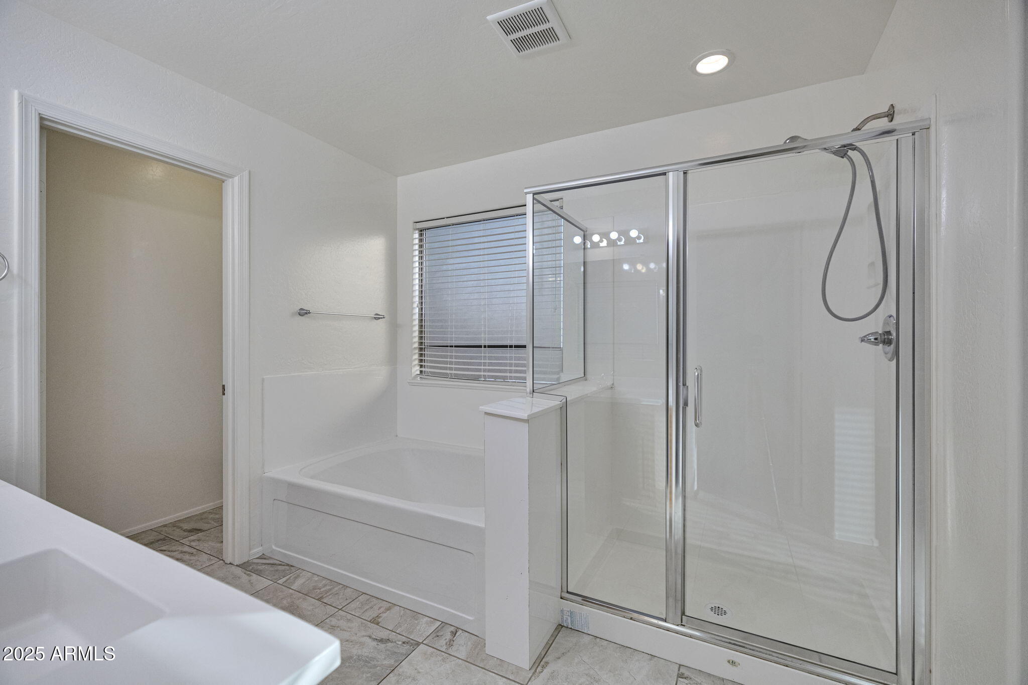 9705 West Riverside Avenue Tolleson, AZ 85353 - Photo 22 of 26 a bathroom with a shower and a bath tub