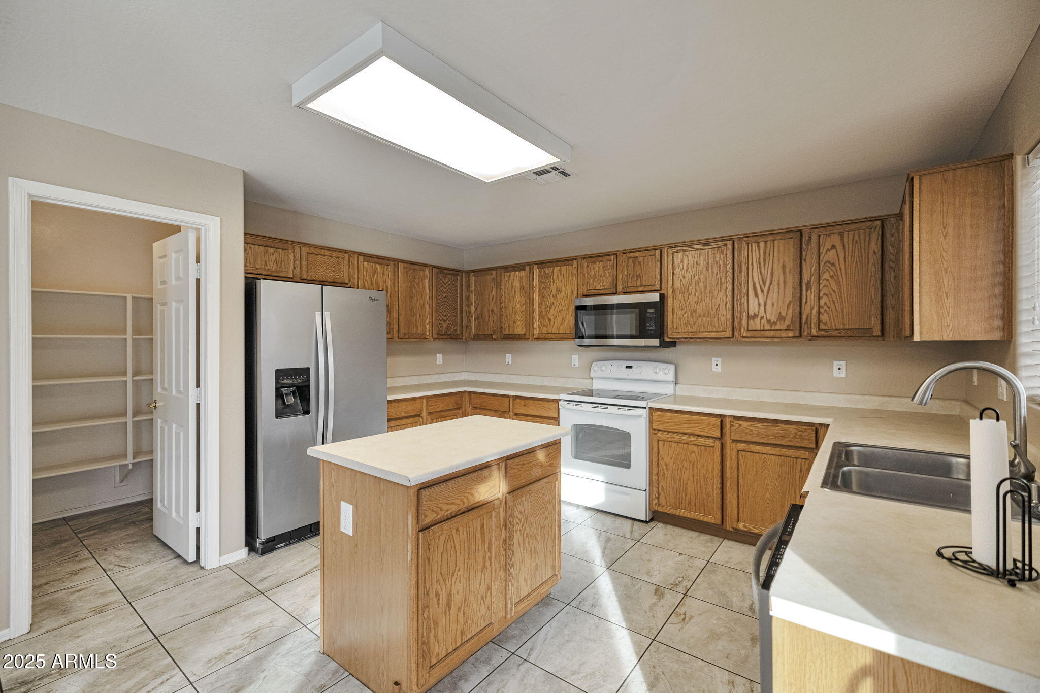 9705 West Riverside Avenue Tolleson, AZ 85353 - Photo 10 of 26 a kitchen with stainless steel appliances granite countertop a refrigerator stove microwave and sink