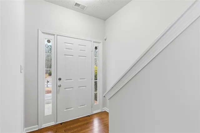 a view of an entryway with wooden floor