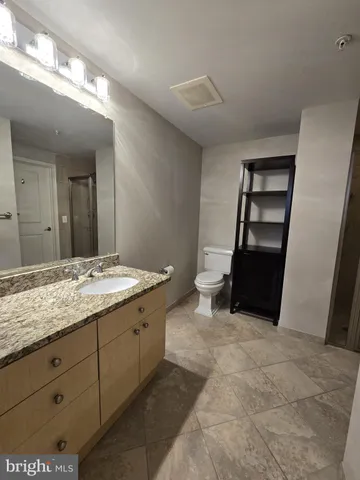 a large bathroom with a sink a mirror and a shower