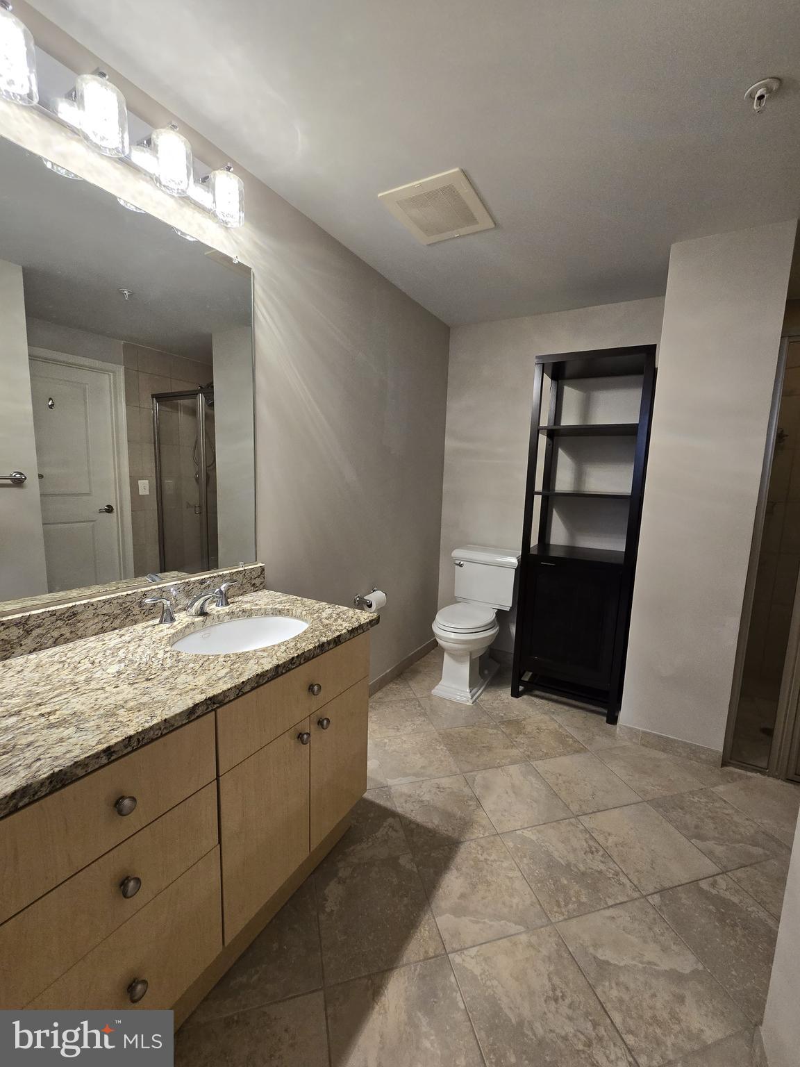 11990 Market Street, Unit 208 Reston, VA 20190 - Photo 12 of 16 a bathroom with a sink and a mirror