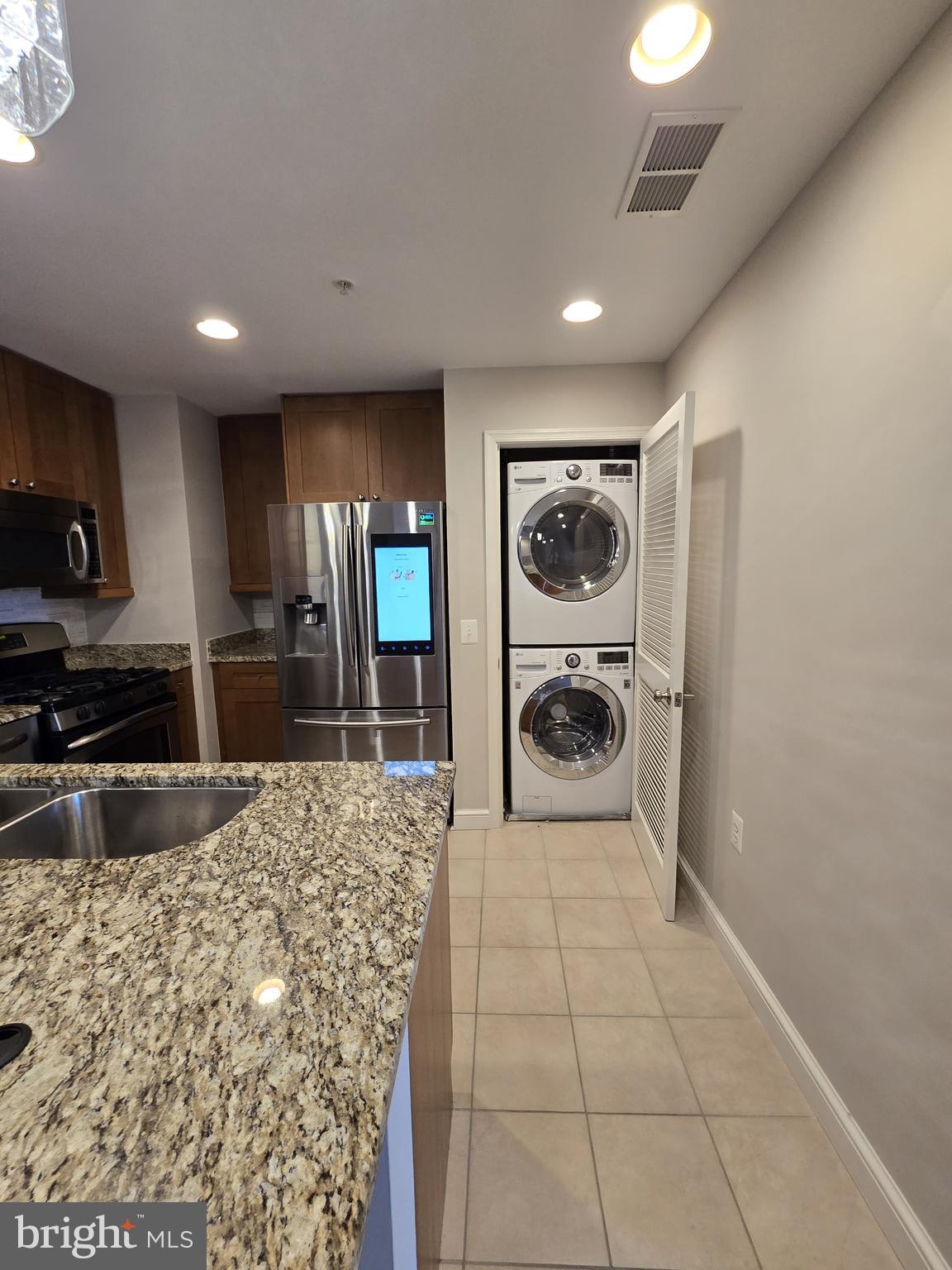 11990 Market Street, Unit 208 Reston, VA 20190 - Photo 13 of 16 a large bathroom with a sink a mirror and a shower