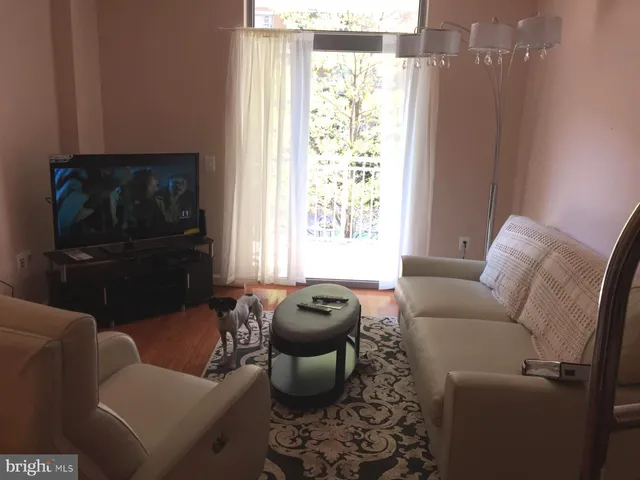 a view of a room with wooden floor