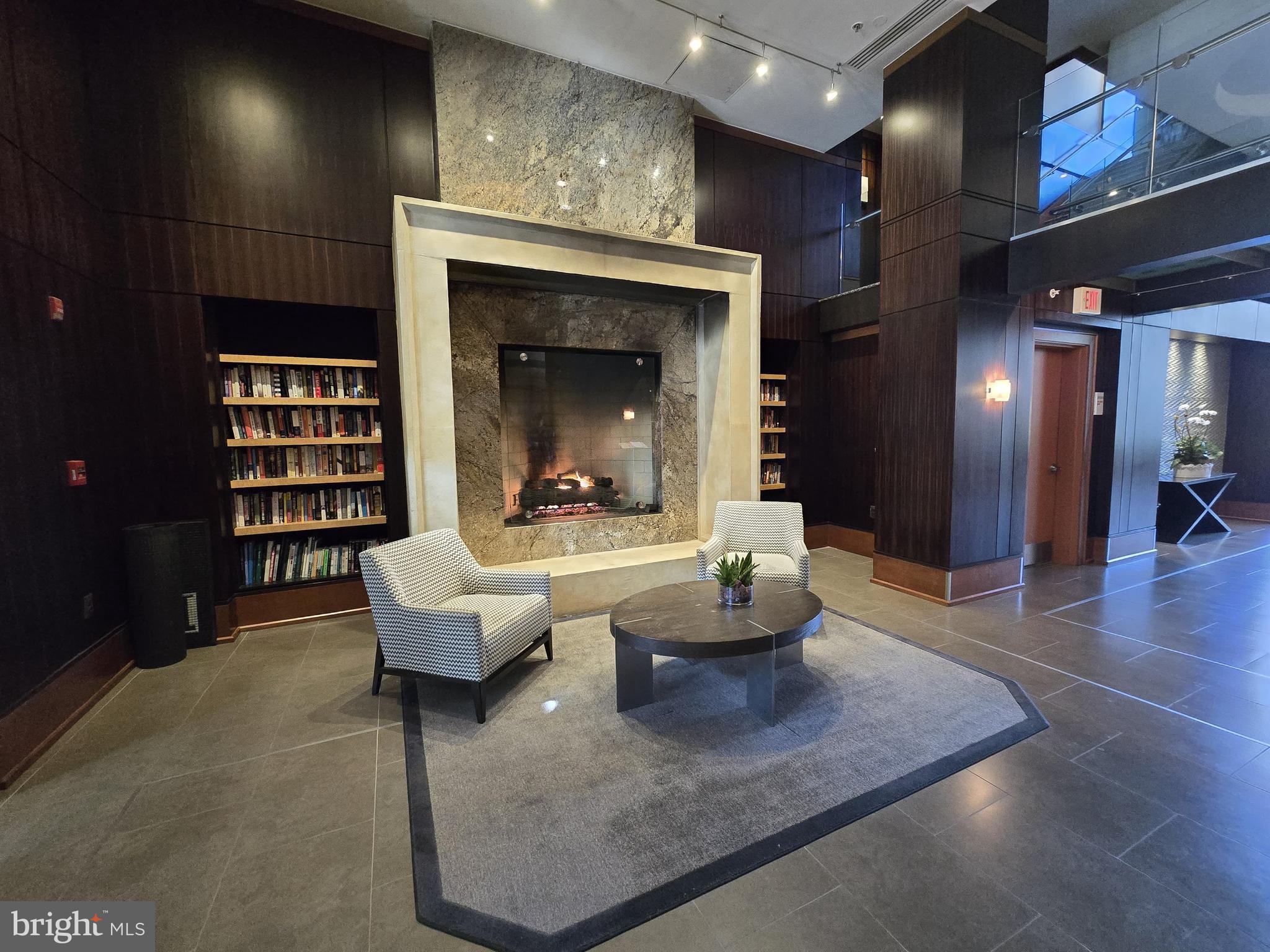 11990 Market Street, Unit 208 Reston, VA 20190 - Photo 6 of 16 a living room with furniture and a fireplace