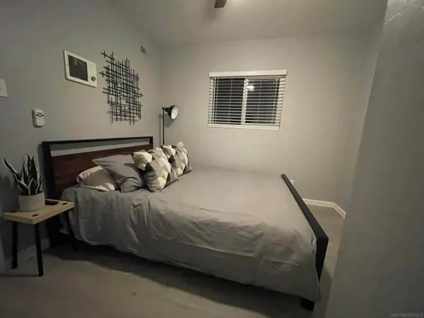 a bedroom with a bed and window