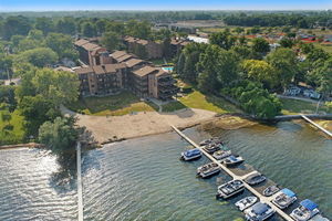 450 North Main Street, Unit S103 Wauconda, IL 60084 - Photo 4 of 14 an aerial view of a house with a yard basket ball court and outdoor seating