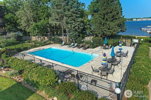 450 North Main Street, Unit S103 Wauconda, IL 60084 - Photo 5 of 14 a view of a swimming pool with lounge chair