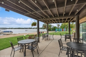 450 North Main Street, Unit S103 Wauconda, IL 60084 - Photo 6 of 14 a view of chairs and table in patio with a lake view