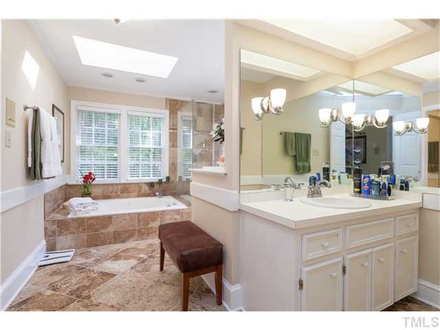 12405 Whartons Way Raleigh, NC 27613 - Photo 9 of 23 UNBELIEVABLE MASTER BATH WITH BEAUTIFUL DETAILS, SKYLIGHTS AND GORGEOUS TILE FLOORS AND TUB/SHOWER SURROUNDS. Master Bath/Spa