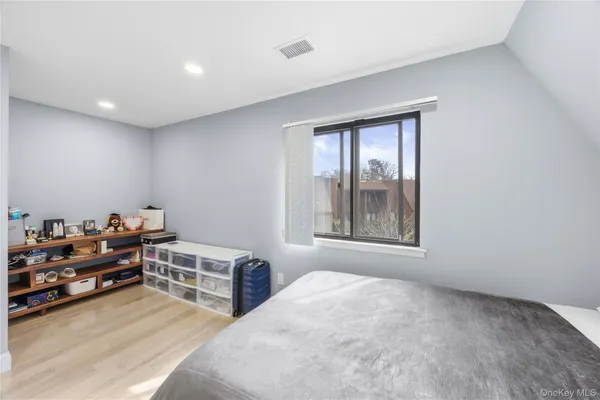 a bedroom with furniture and a window