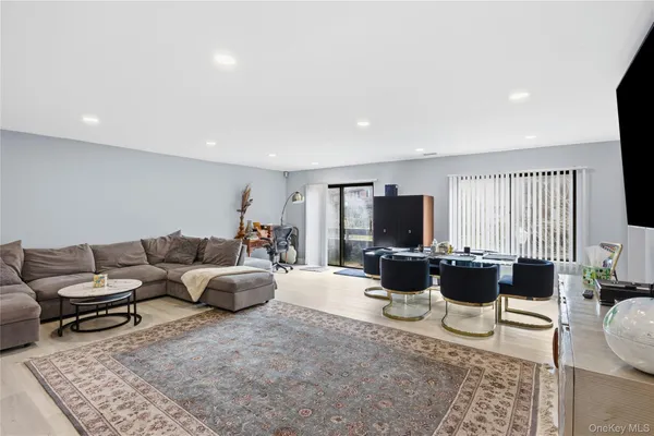 a living room with furniture wooden floor and a flat screen tv