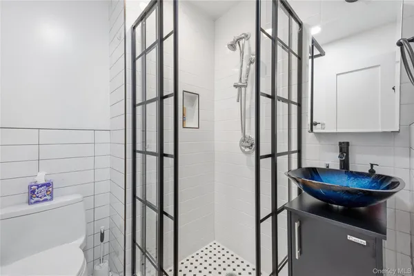 a bathroom with a sink toilet and shower