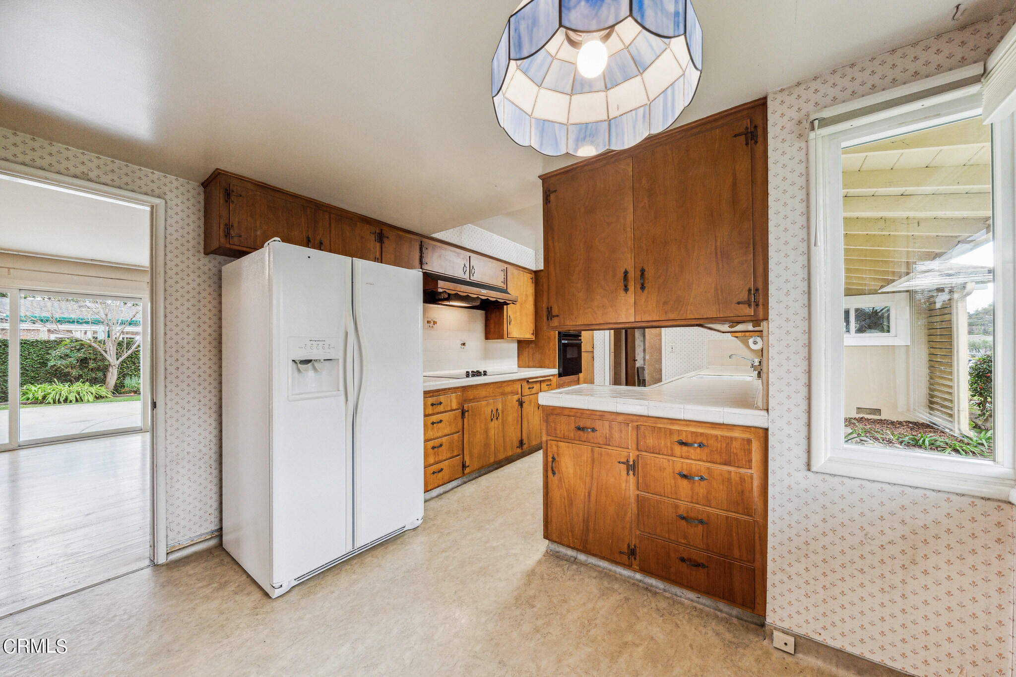 390 San Juan Place Pasadena, CA 91107 - Photo 11 of 29 a kitchen with cabinets a window and stainless steel appliances
