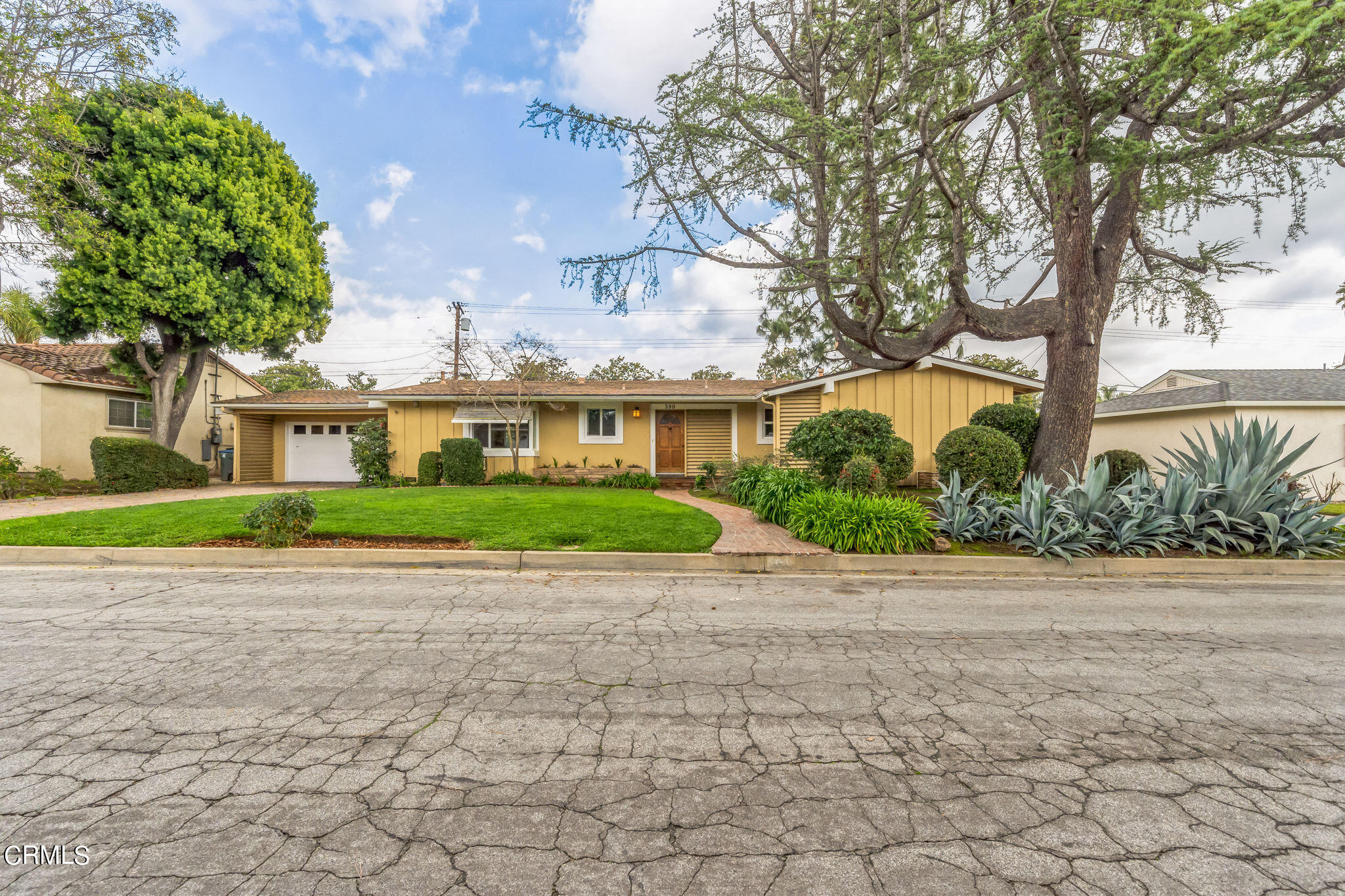 390 San Juan Place Pasadena, CA 91107 - Photo 26 of 29 a view of white house with a yard and large trees