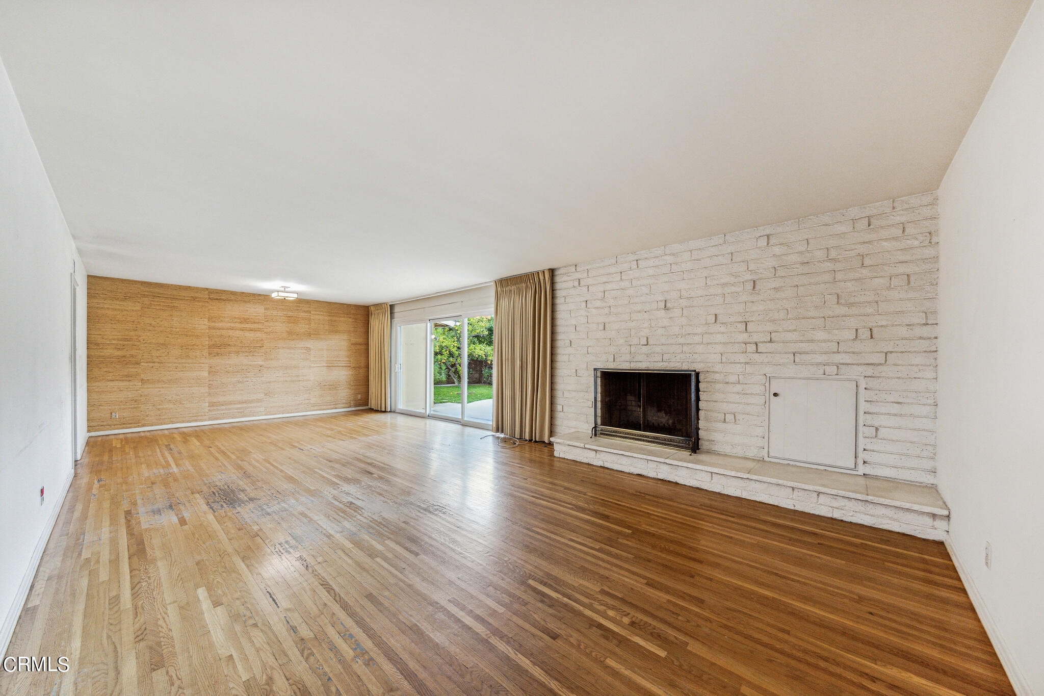 390 San Juan Place Pasadena, CA 91107 - Photo 3 of 29 a view of an empty room with wooden floor fireplace and a window