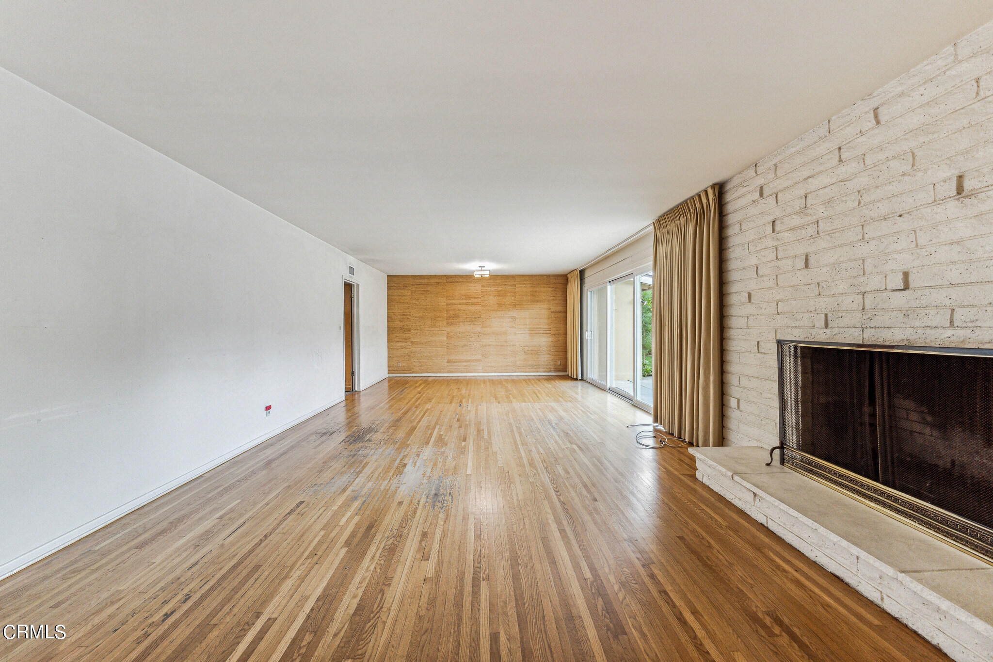 390 San Juan Place Pasadena, CA 91107 - Photo 4 of 29 a view of empty room with wooden floor and fireplace