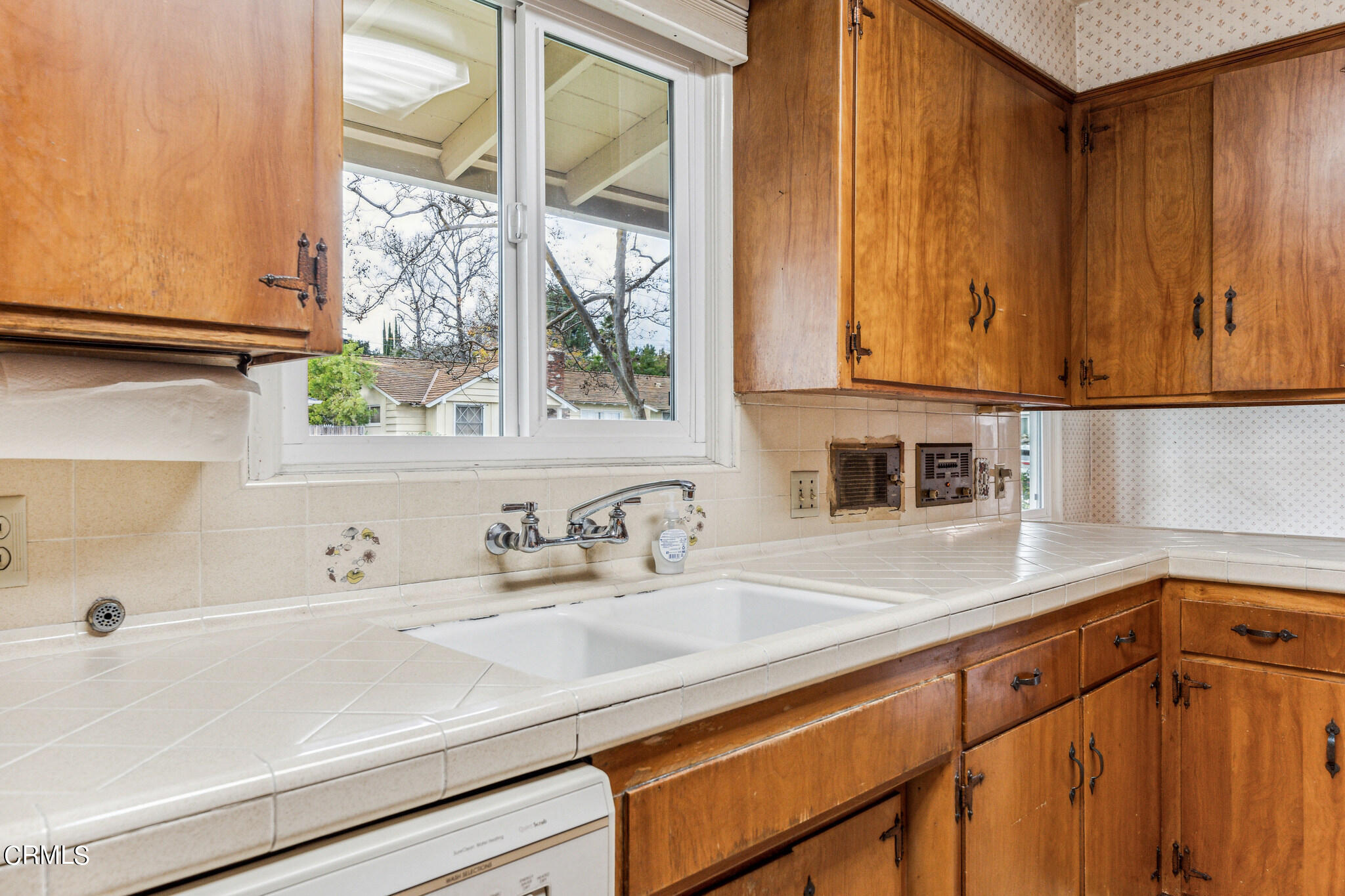 390 San Juan Place Pasadena, CA 91107 - Photo 7 of 29 a kitchen with stainless steel appliances a sink dishwasher window and cabinets