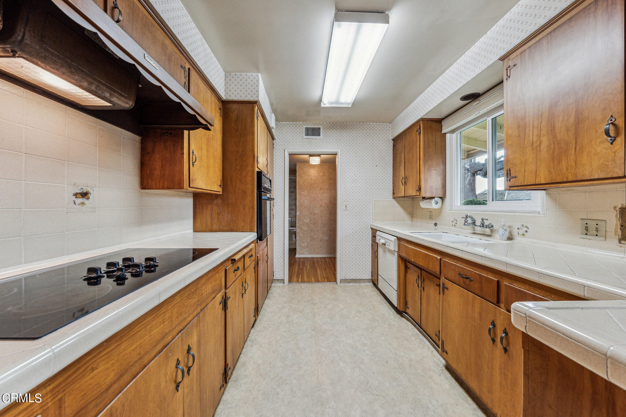390 San Juan Place Pasadena, CA 91107 - Photo 8 of 29 a kitchen with stainless steel appliances kitchen island a sink stove and cabinets