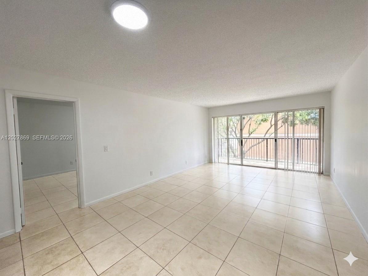 8761 Wiles Road, Unit 206 Coral Springs, FL 33067 - Photo 4 of 26 a view of an empty room with a window
