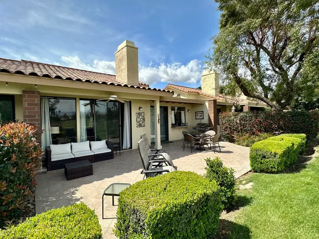 a view of a house with sitting area and garden