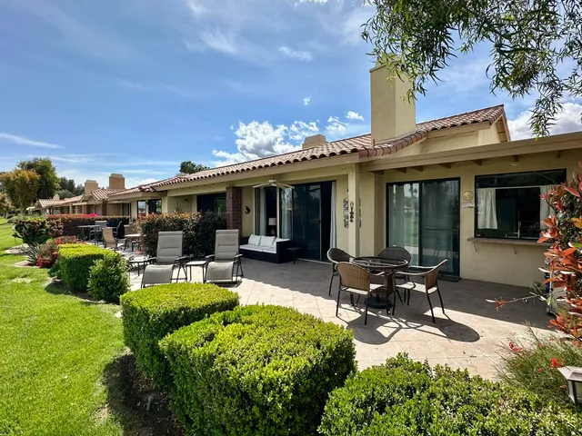 a view of a house with backyard porch and sitting area