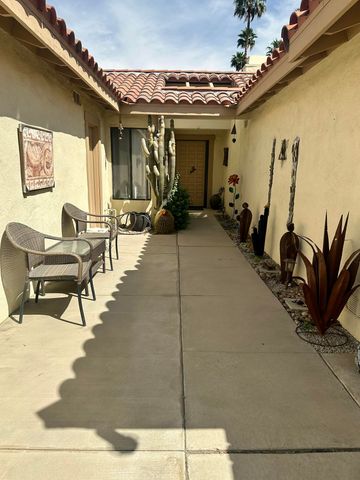 a view of a patio with table and chairs