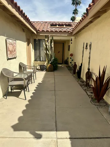 a view of a patio with table and chairs