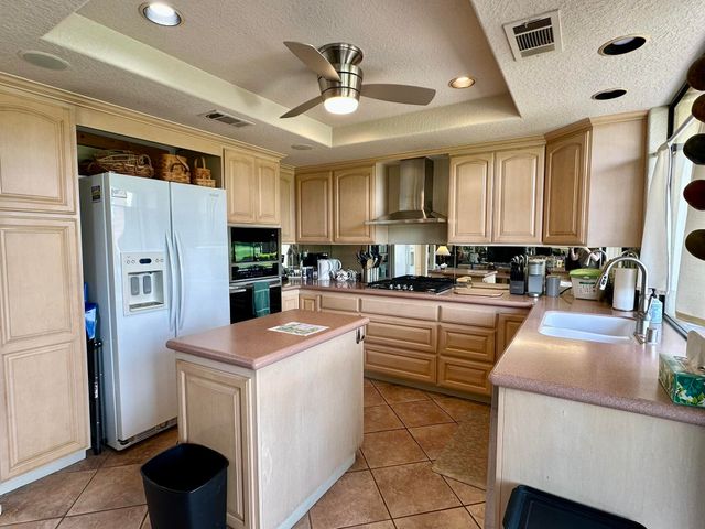 a kitchen with refrigerator and cabinets