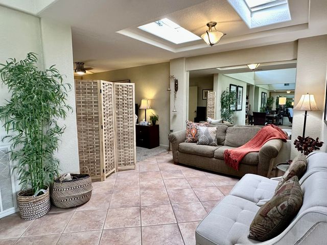 a living room with furniture and a potted plant