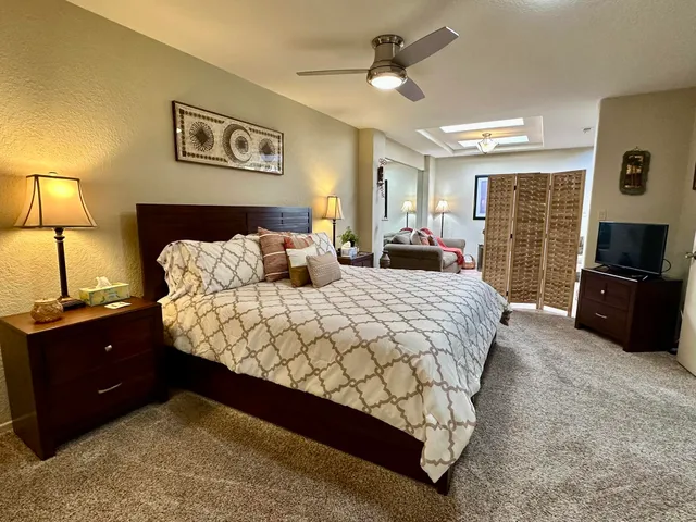 a bedroom with a bed and dresser